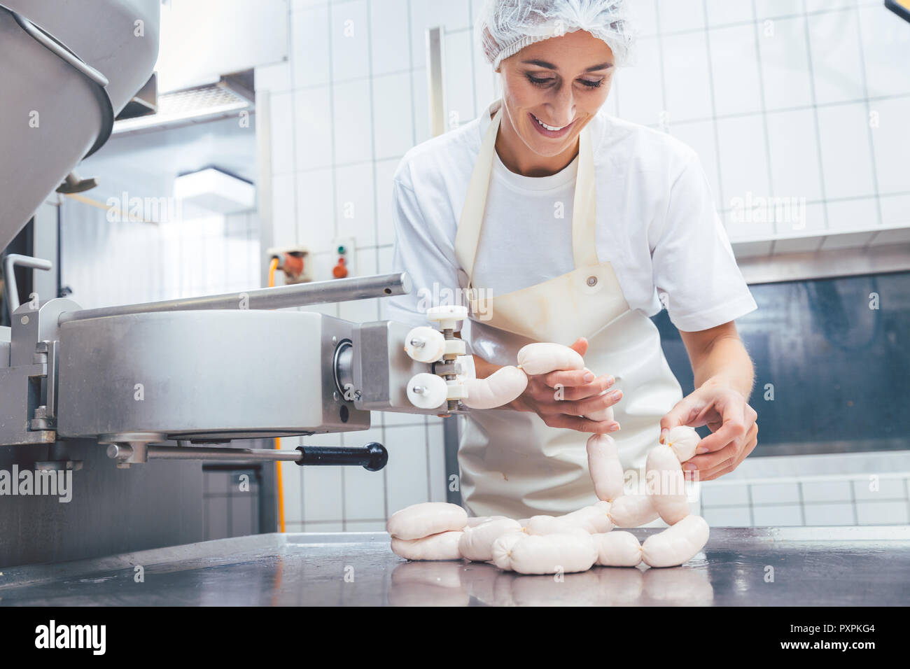 Woman making sausages in butchery  Stock Photo