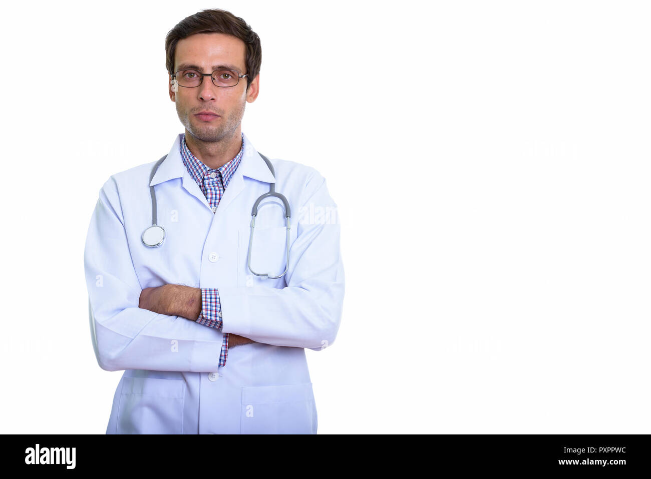 Studio shot of young handsome man doctor wearing eyeglasses with Stock Photo