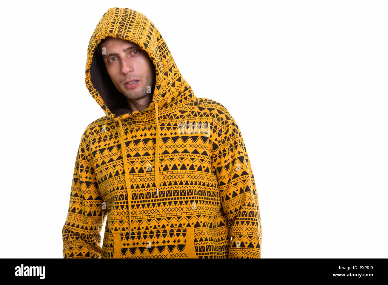 Studio shot of young handsome man wearing hoodie and posing  Stock Photo