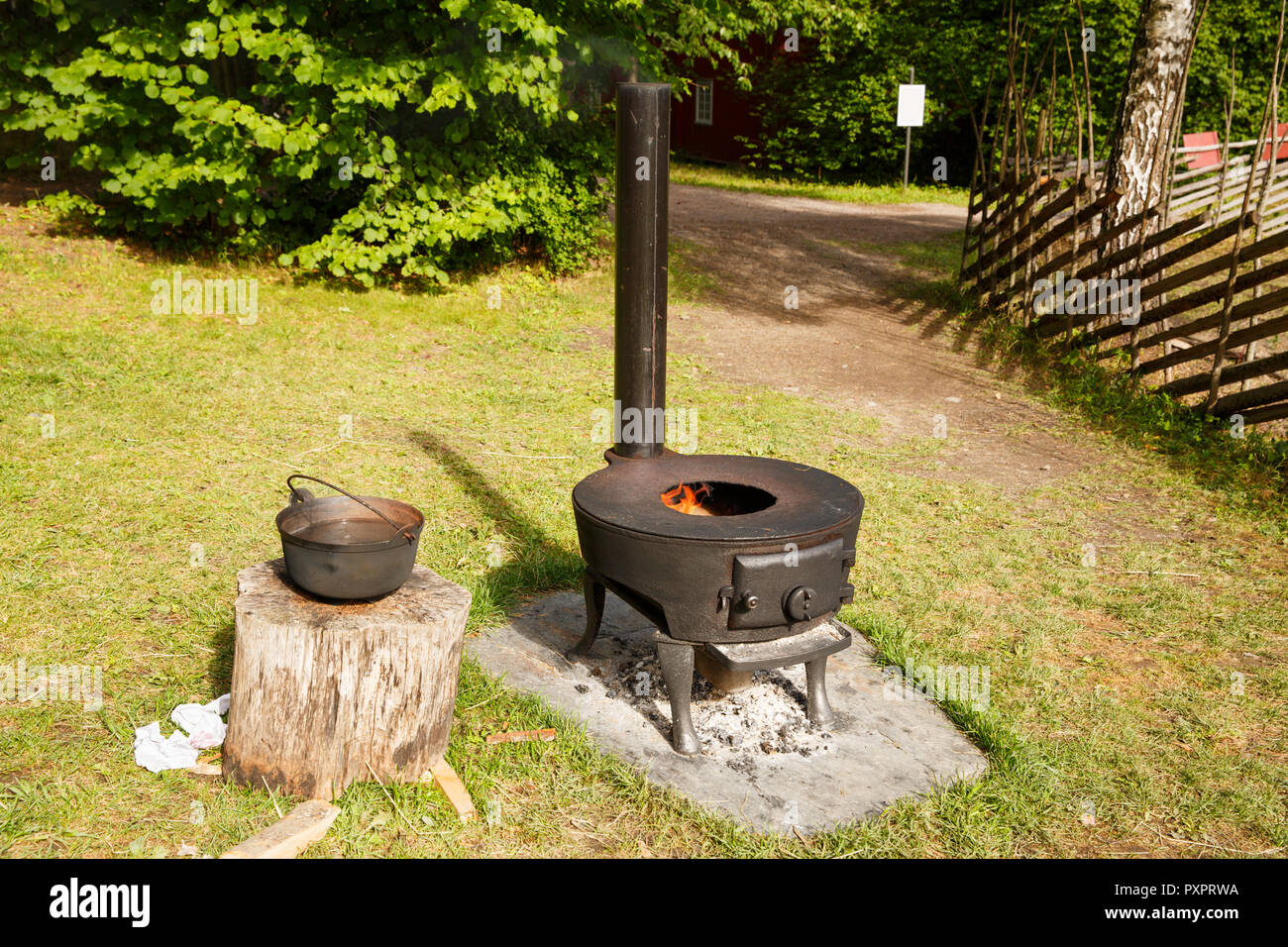 Norwegian vintage stove with fire in Folk museum in Oslo. Stock Photo