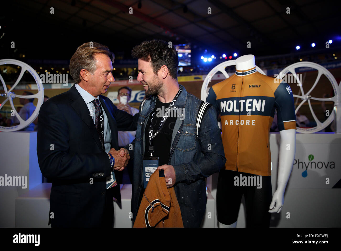 Mario Molteni presents a Molteni official jersey to Mark Cavendish in hospitality during day one of the Six Day Series at Lee Valley Velopark, London. Stock Photo
