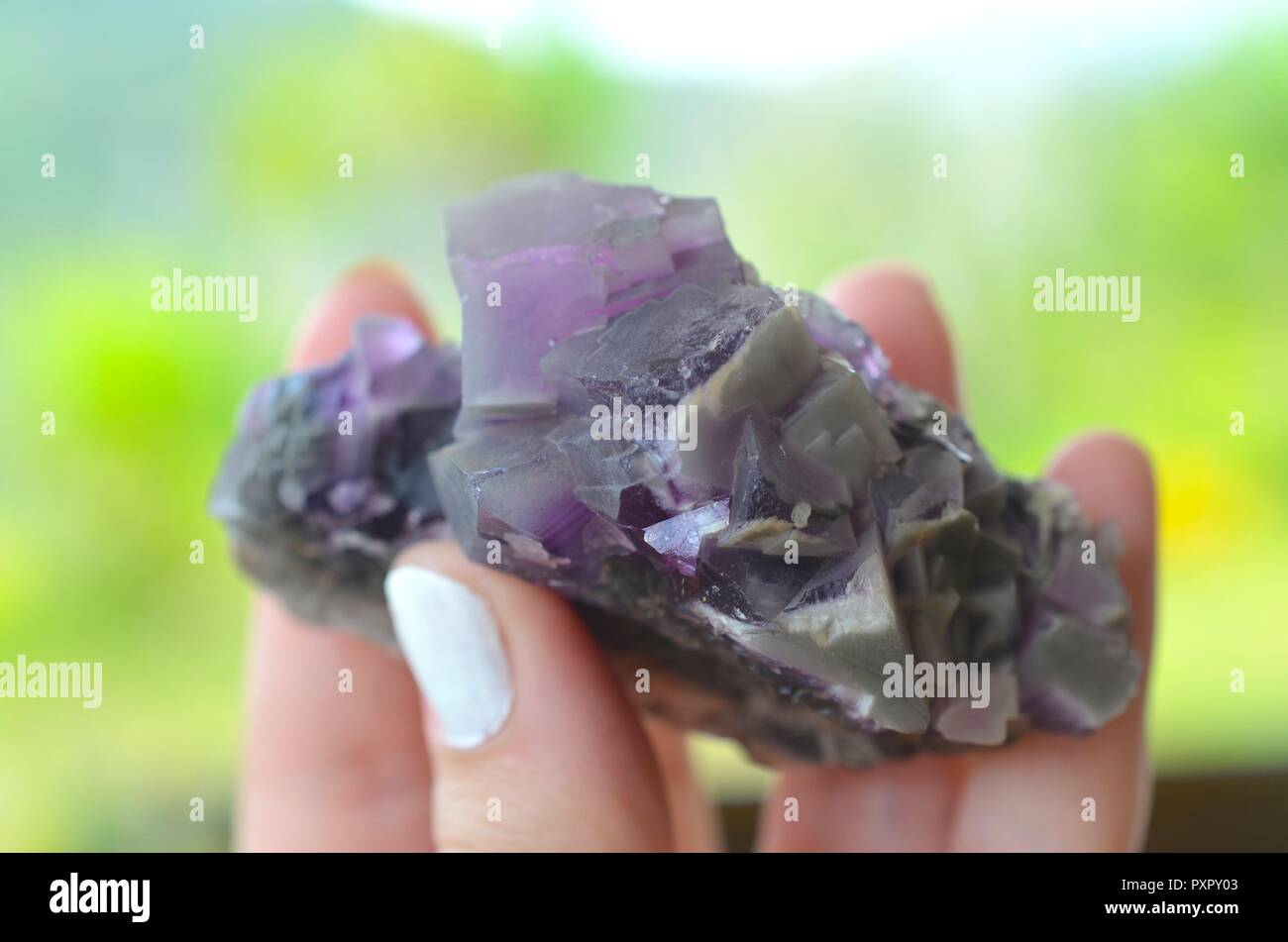Natural Purple Cubic Fluorite Cluster. Purple fluorite natural crystal, Beautiful Fluorite for grids! Protective, stabilizing, grounding witchcraft. Stock Photo