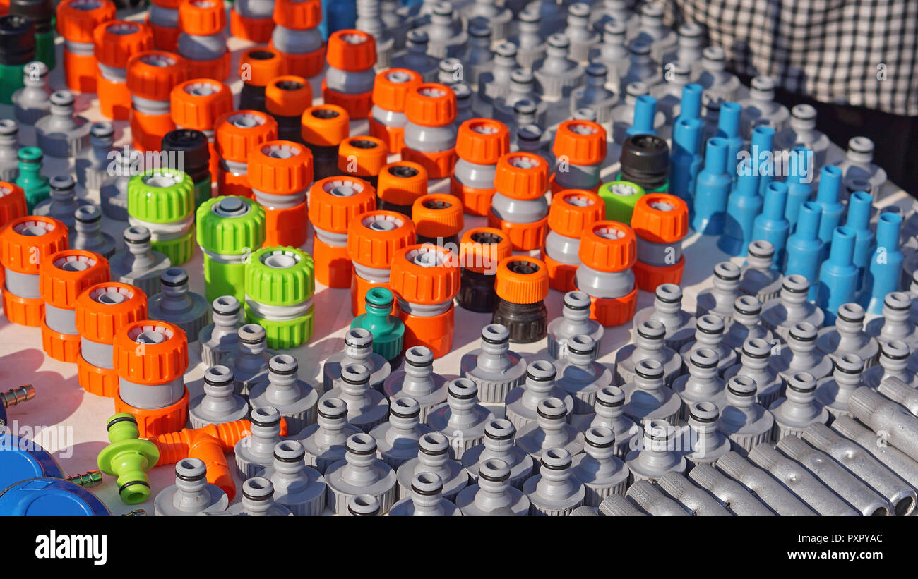 Various colorful garden hose nozzles sprayer valves parts Stock Photo
