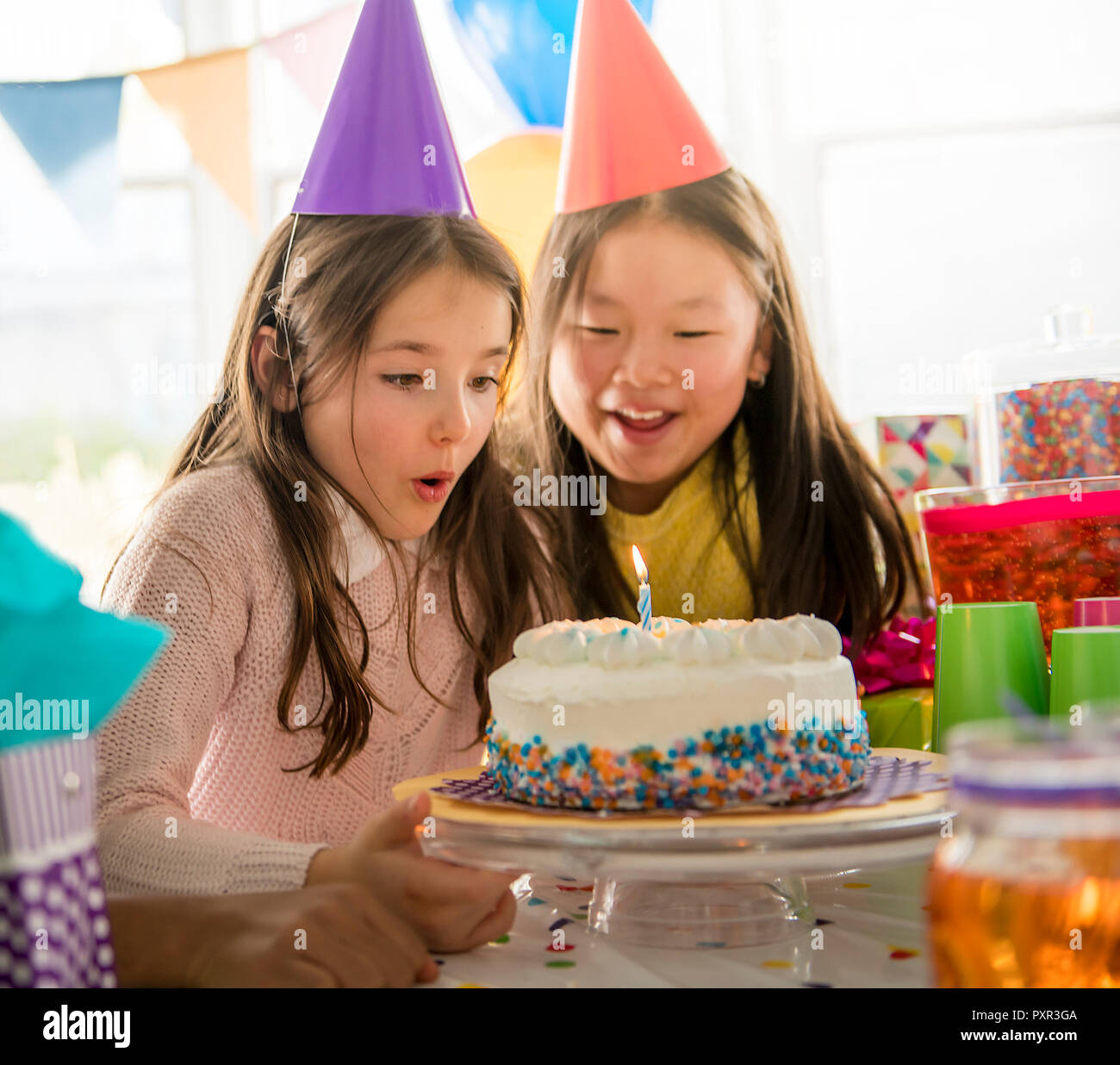 two adorable kids having fun at birthday party Stock Photo