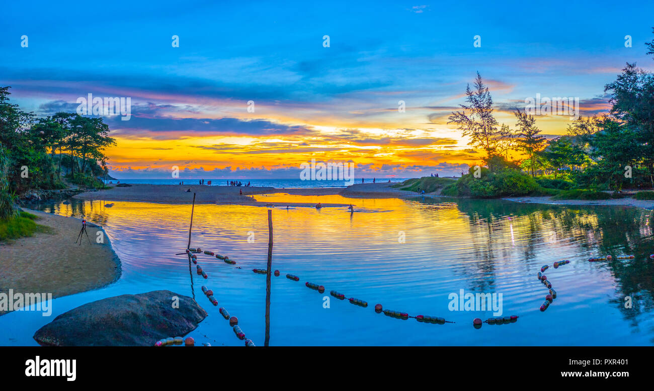 aerial view reflection of sunset in Naiharn lake. water from the lake flow down in to Nai Harn beach Stock Photo