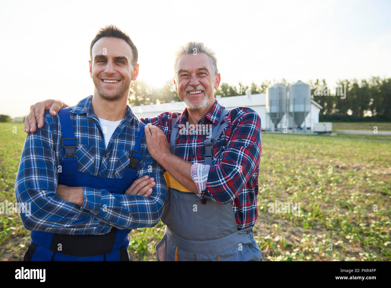 Portrait of two farmers proud of their farm Stock Photo