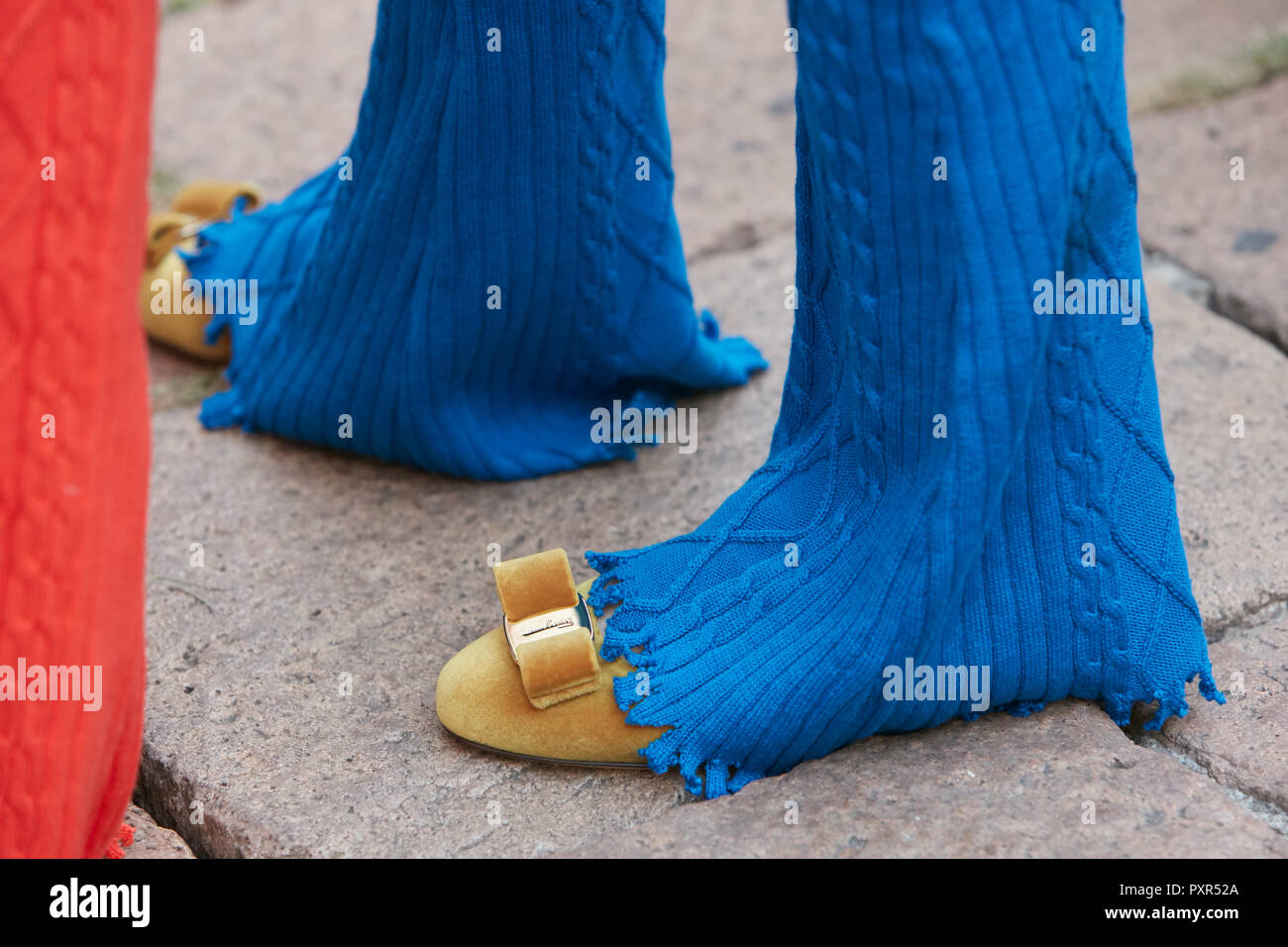 MILAN, ITALY - SEPTEMBER 22, 2018: Woman with blue, soft trousers and  yellow velvet Ferragamo shoes before Salvatore Ferragamo fashion show,  Milan Fas Stock Photo - Alamy