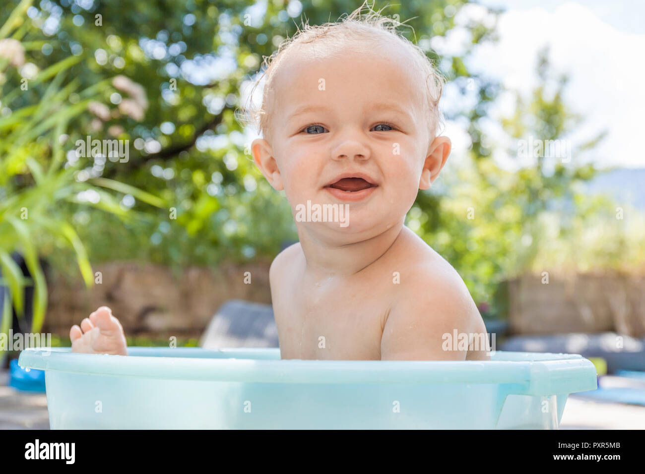 Boy sitting in baby bathtub Stock Photo Alamy