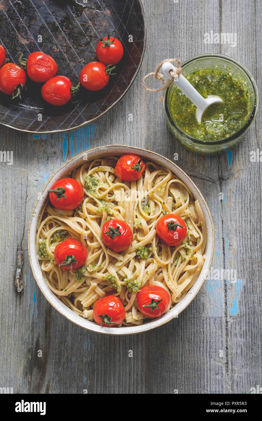 Homemade whole-grain ribbon noodles with pesto and cherry tomatoes ...