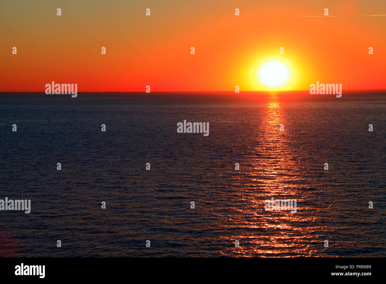 Sunset, over Sea, red sky, The Wash, west facing coast, Hunstanton, Norfolk, England UK Stock Photo