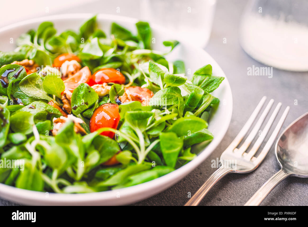 Lamb's lettuce with tomatoes and walnuts Stock Photo