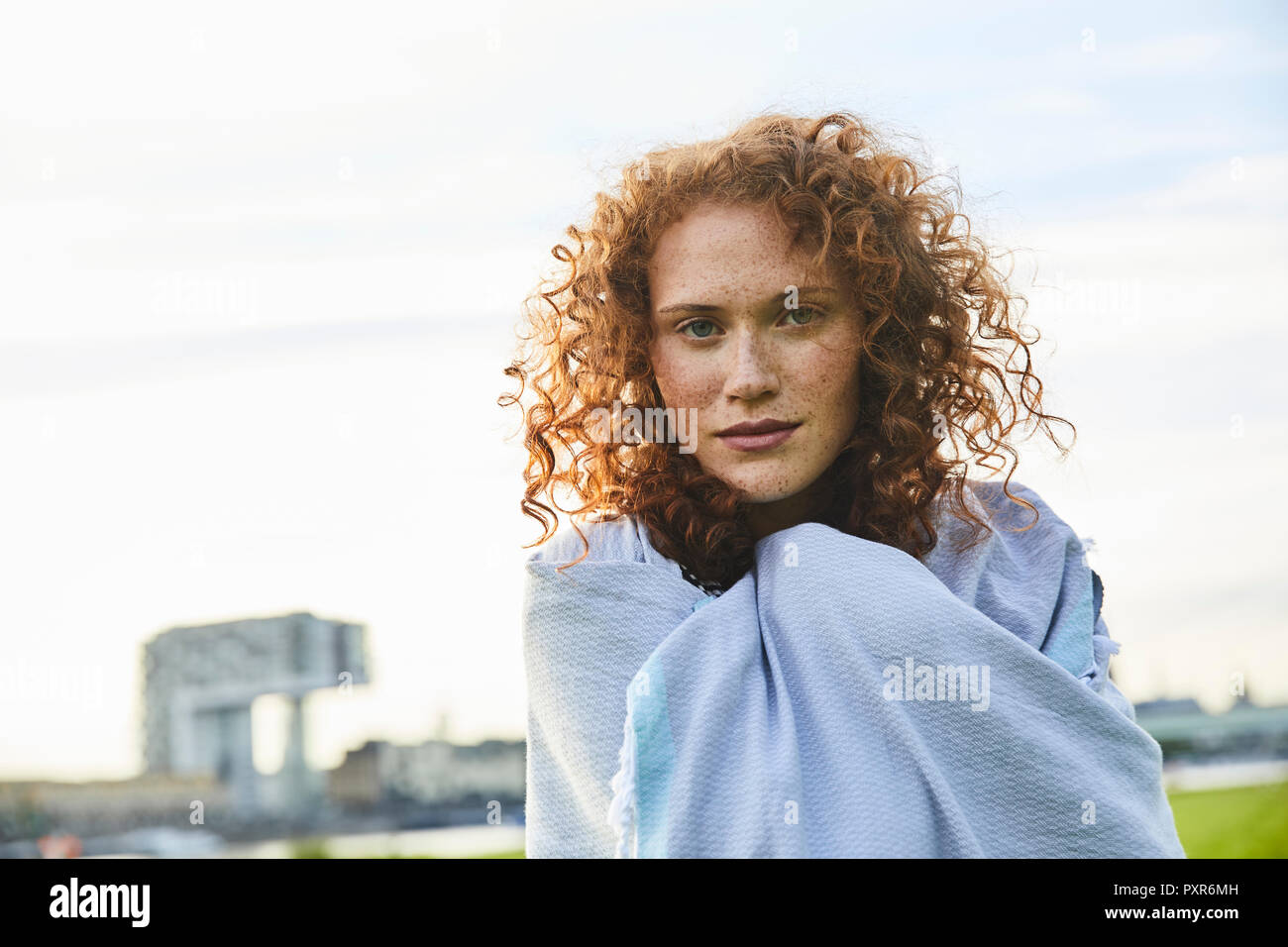 Germany, Cologne, portrait of freckled young woman Stock Photo