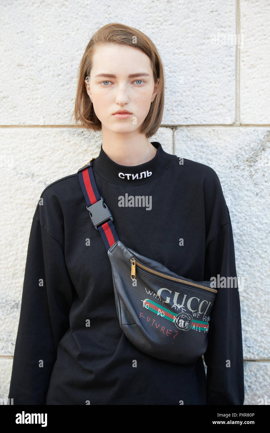 MILAN, ITALY - SEPTEMBER 22, 2018: Top model with black Gucci pouch with  Gabriele Colangelo before fashion show, Milan Fashion Week street style  Stock Photo - Alamy