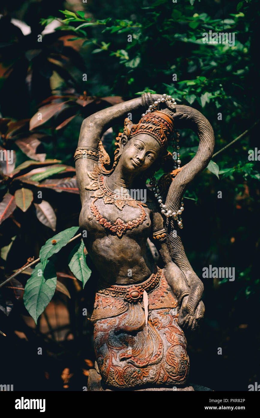 Thailand, Chiang Mai, Buddhist statue in the middle of the jungle in Wat Pha Lat Buddhist temple Stock Photo