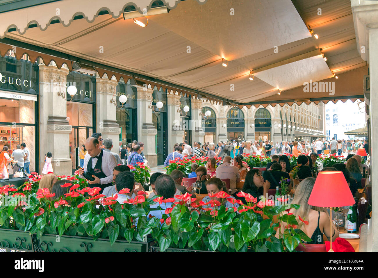 People eating at restaurant inside the Galleria Vittorio Emanuele II, Milan, Italy. Stock Photo
