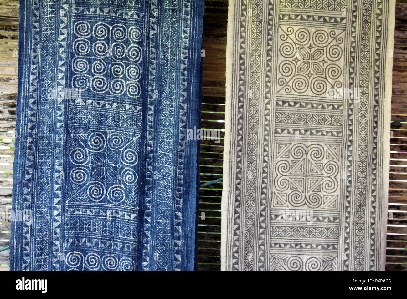 Blue Hmong batik designs made from hot wax on hemp cloth, showing before and after indigo dye bath at Ock Pop Tok, Luang Prabang, Laos Stock Photo