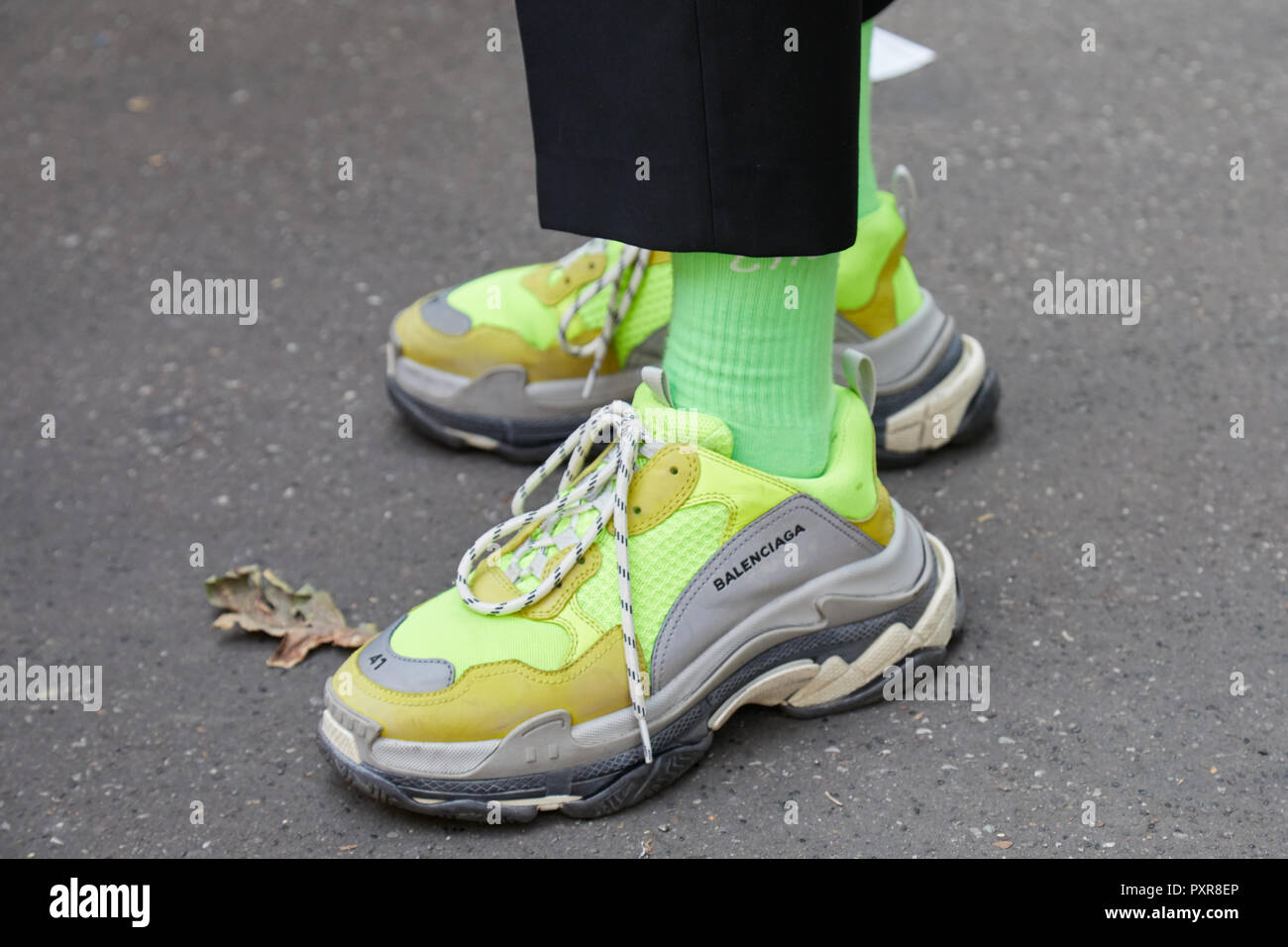 MILAN, ITALY - SEPTEMBER 22, 2018: Man with yellow green Balenciaga sneakers  before Simonetta Ravizza fashion show, Milan Fashion Week street style  Stock Photo - Alamy