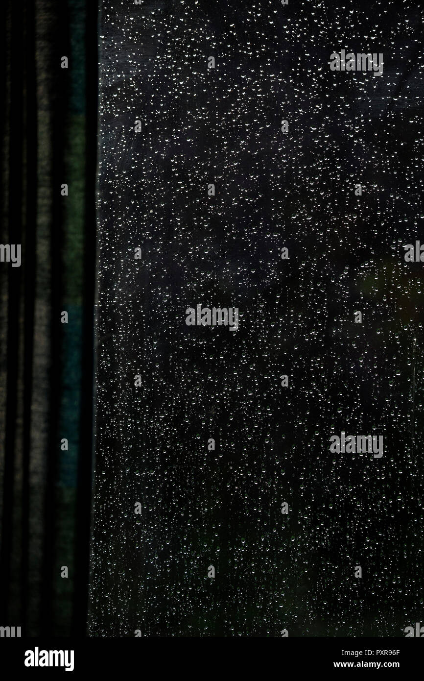 Raindrops on windowpane seen from inside Stock Photo