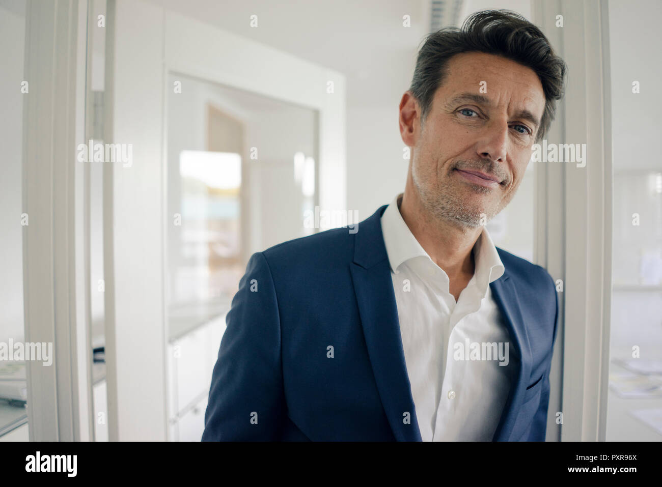 Businessman office leaning door frame hires stock photography and images Alamy