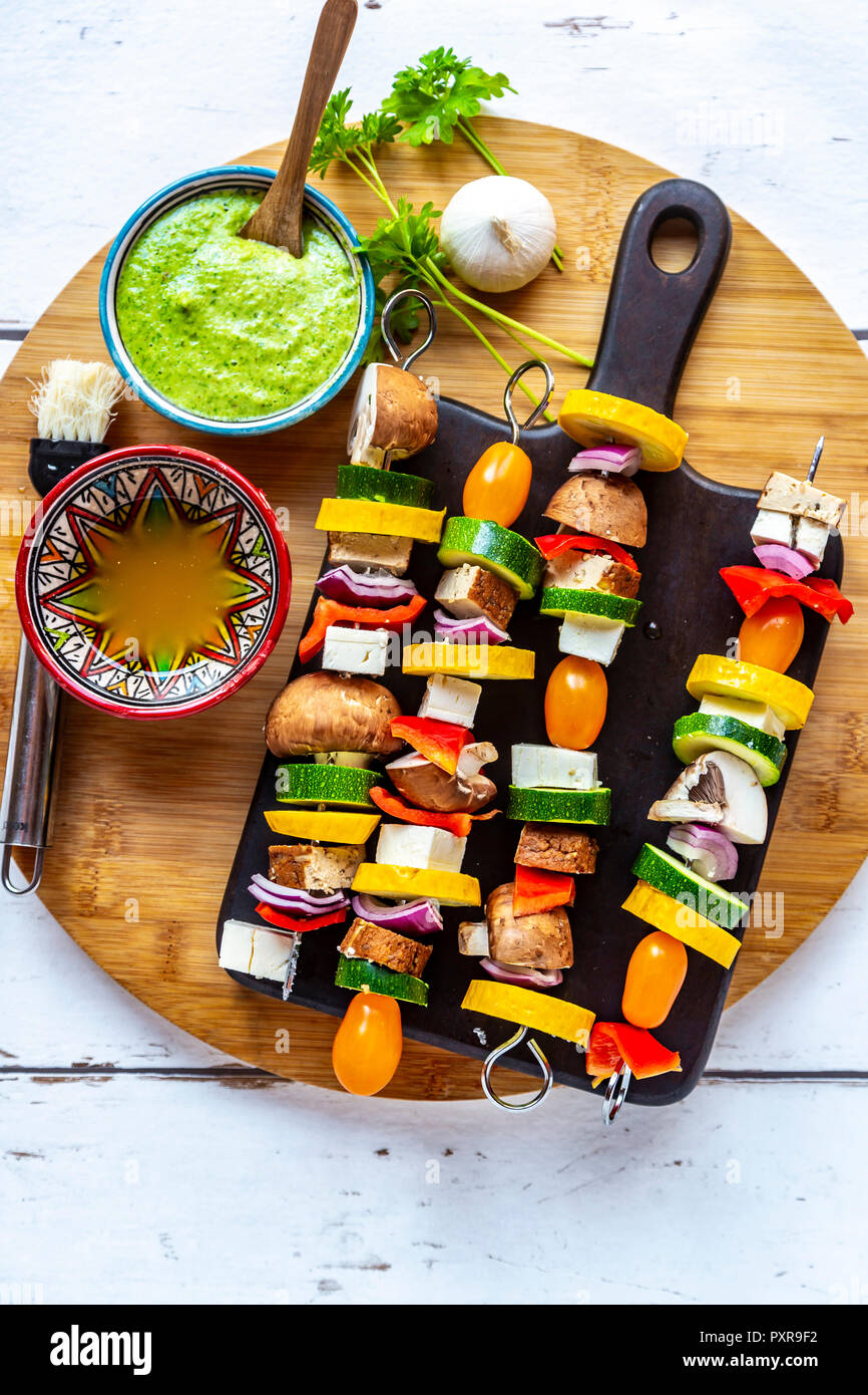 Vegetarian grill skewers, tomato, yellow and green zucchini, tofu, feta,  onion and champignon, Argentinian chimichurri Stock Photo - Alamy