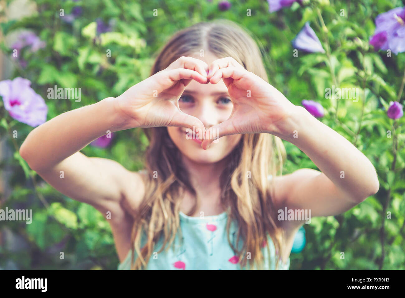 Young Girl Making A Heart Shape With Her Fingers Stock Photo Alamy