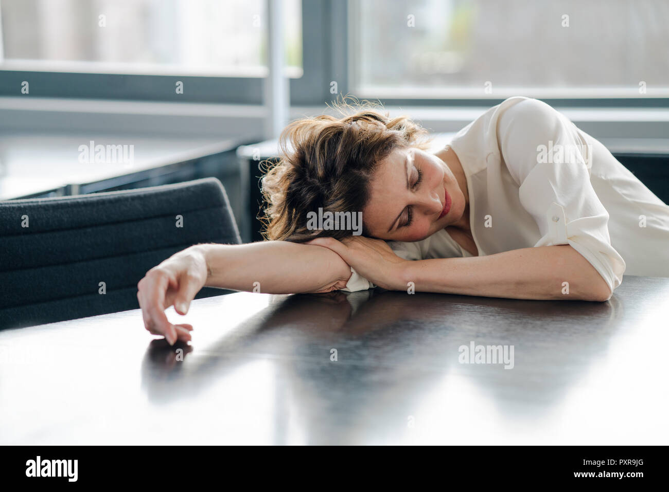 Tired businesswoman sleeping on her desk Stock Photo - Alamy