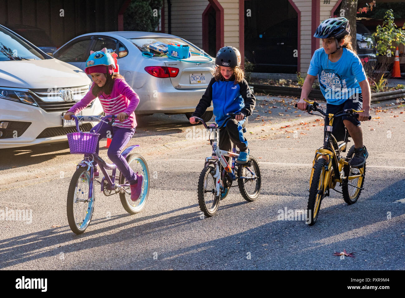 Young children have bicycle race Stock Photo