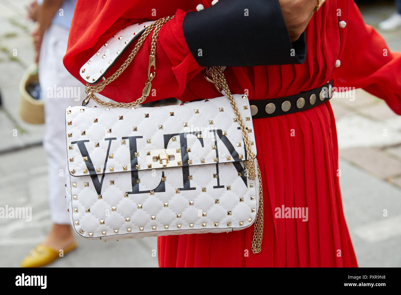 MILAN, ITALY - SEPTEMBER 22, 2018: Woman with white Valentino bag with  golden studs and red dress before Philosophy fashion show, Milan Fashion  Week s Stock Photo - Alamy