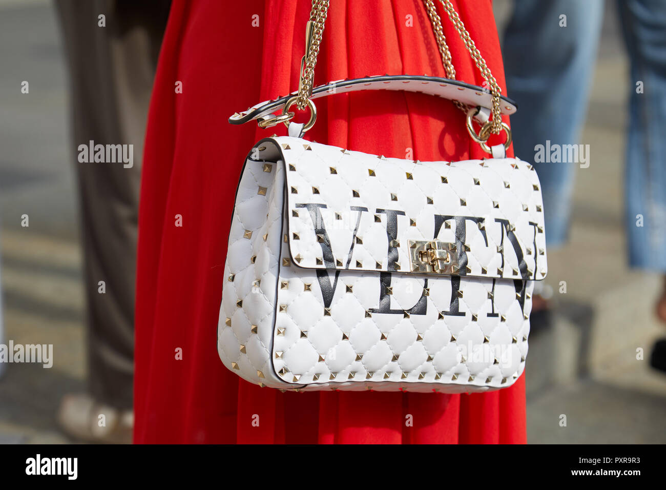 MILAN, ITALY - SEPTEMBER 22, 2018: Woman with red skirt and white leather Valentino  bag with studs before Philosophy fashion show, Milan Fashion Week Stock  Photo - Alamy