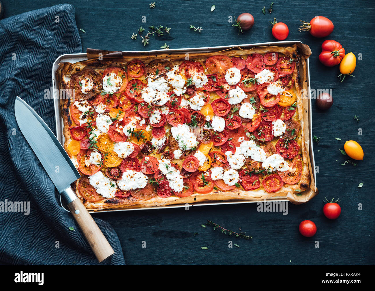 Tomato tart with goat cheese and thyme on mustard Stock Photo