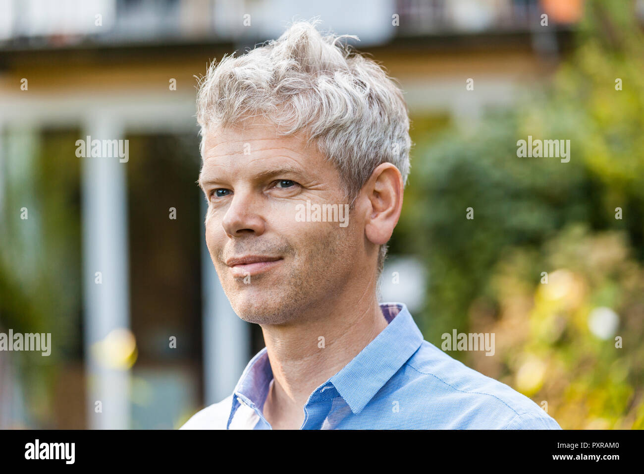 Portrait of smiling mature man with Stock Photo