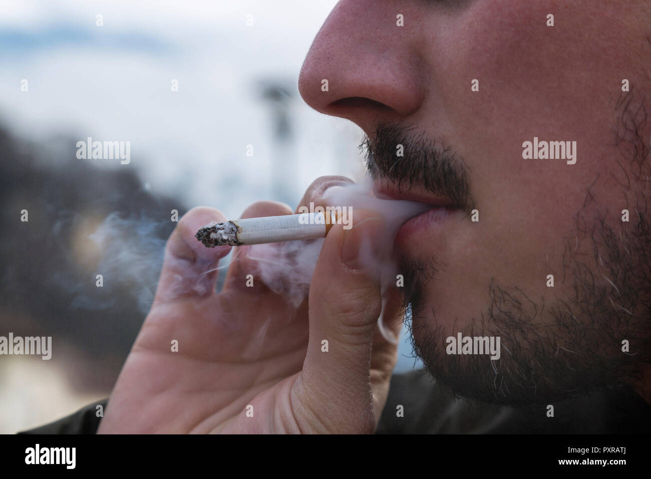 Detail of smoker, cigarette and smoke Stock Photo