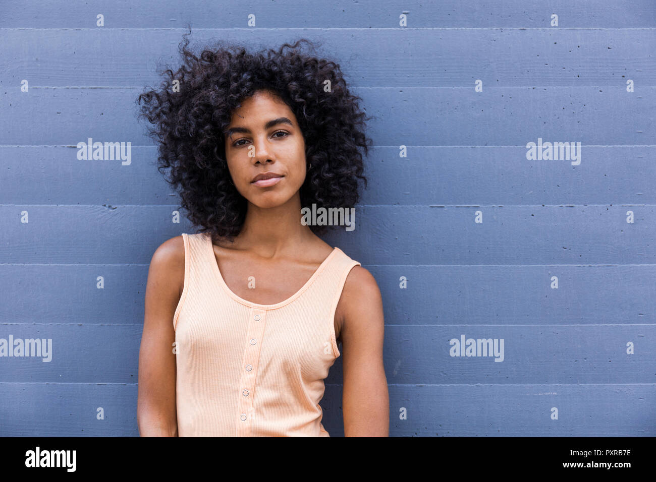 Portrait of young woman with curly black hair Stock Photo