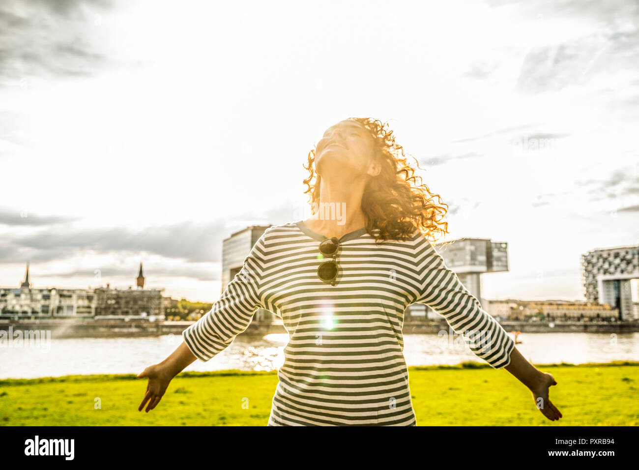 Germany, Cologne, young woman enjoying sunlight Stock Photo