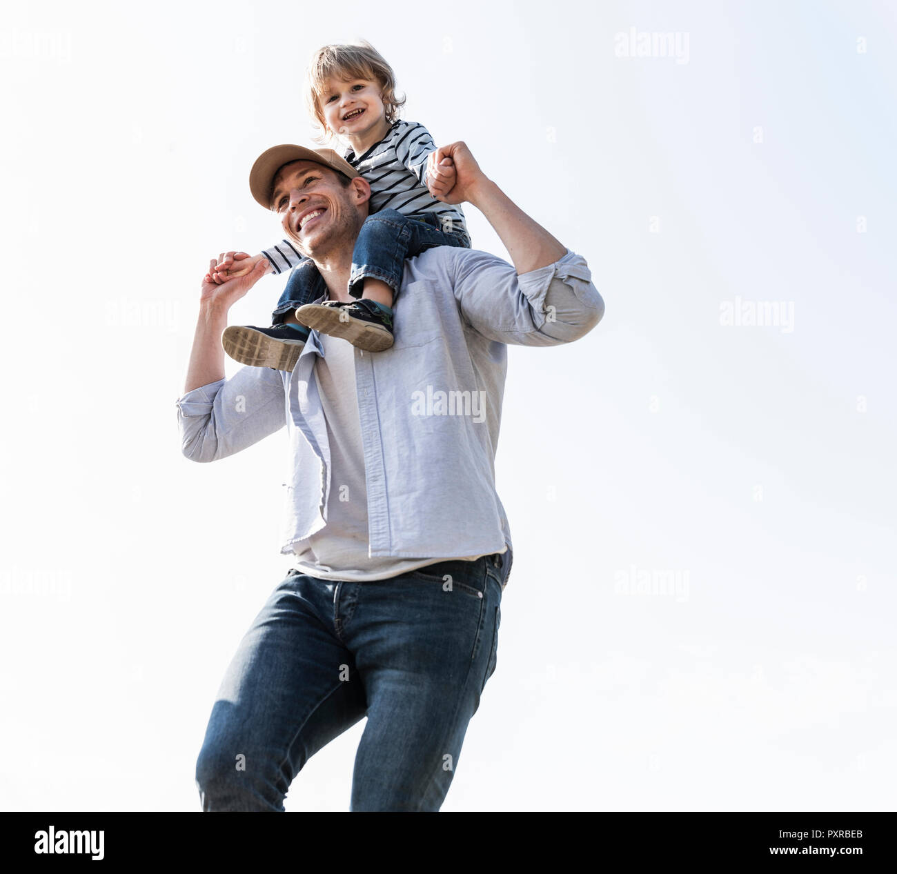 Happy father carrying son on his shoulders Stock Photo - Alamy