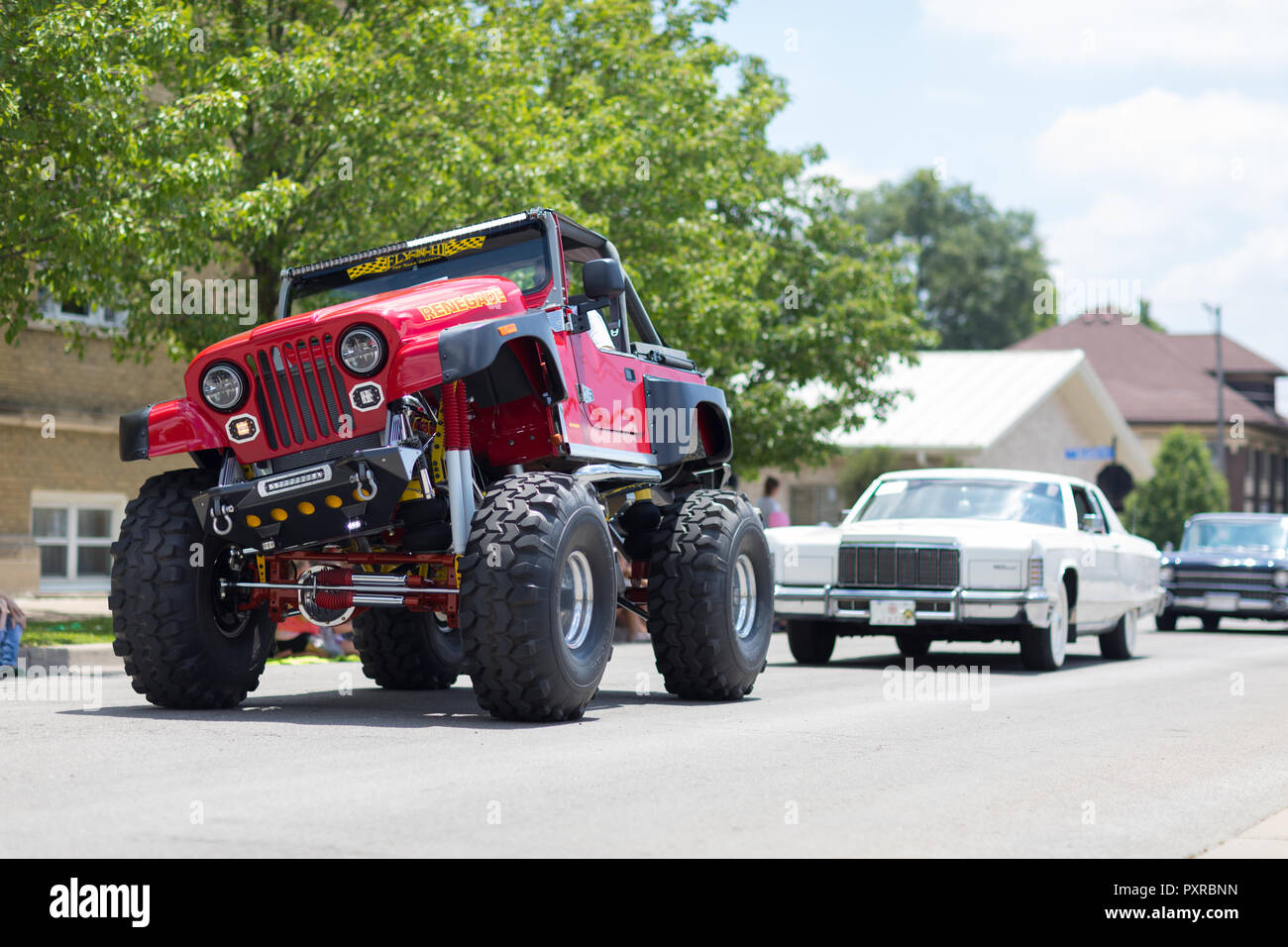 Kokomo, Indiana, USA - June 30, 2018: Haynes Apperson Parade, A Jeep Renegade Modified for off road recreation color red going down the street during  Stock Photo