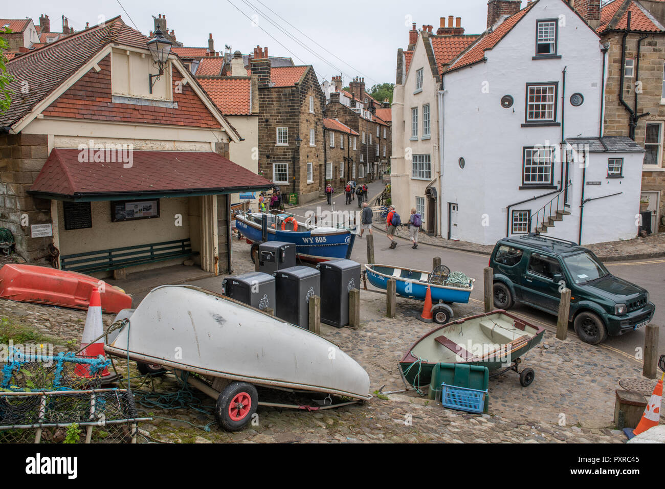 A group of small boats rest on the side of the road, Robin Hood's bay, Yorkshire, UK Stock Photo