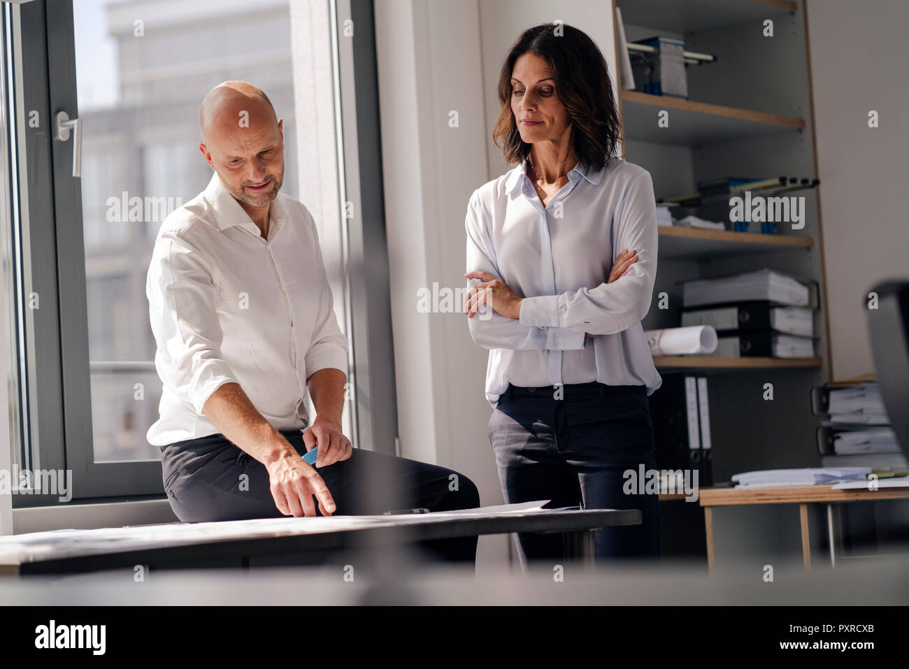Two architects working in office, discussing blueprints Stock Photo