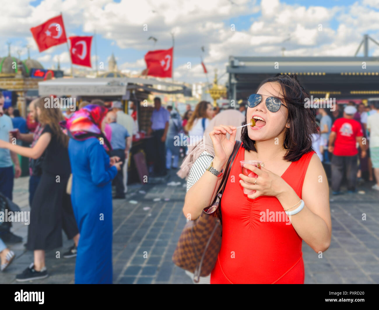 Beautiful Chinese woman eats traditional vegetable pickles at Eminonu