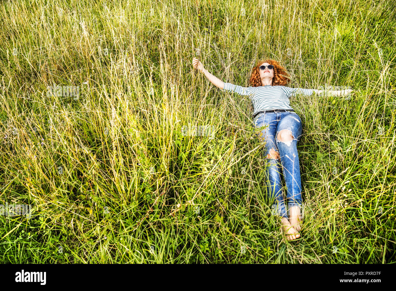 Young woman relaxing on a meadow Stock Photo