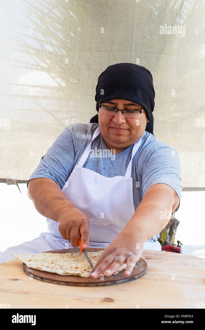 ALANYA, TURKEY - June 20: unidentified Woman, prepares pita bread on the street market. Pita bread with cottage cheese and greens. Stock Photo