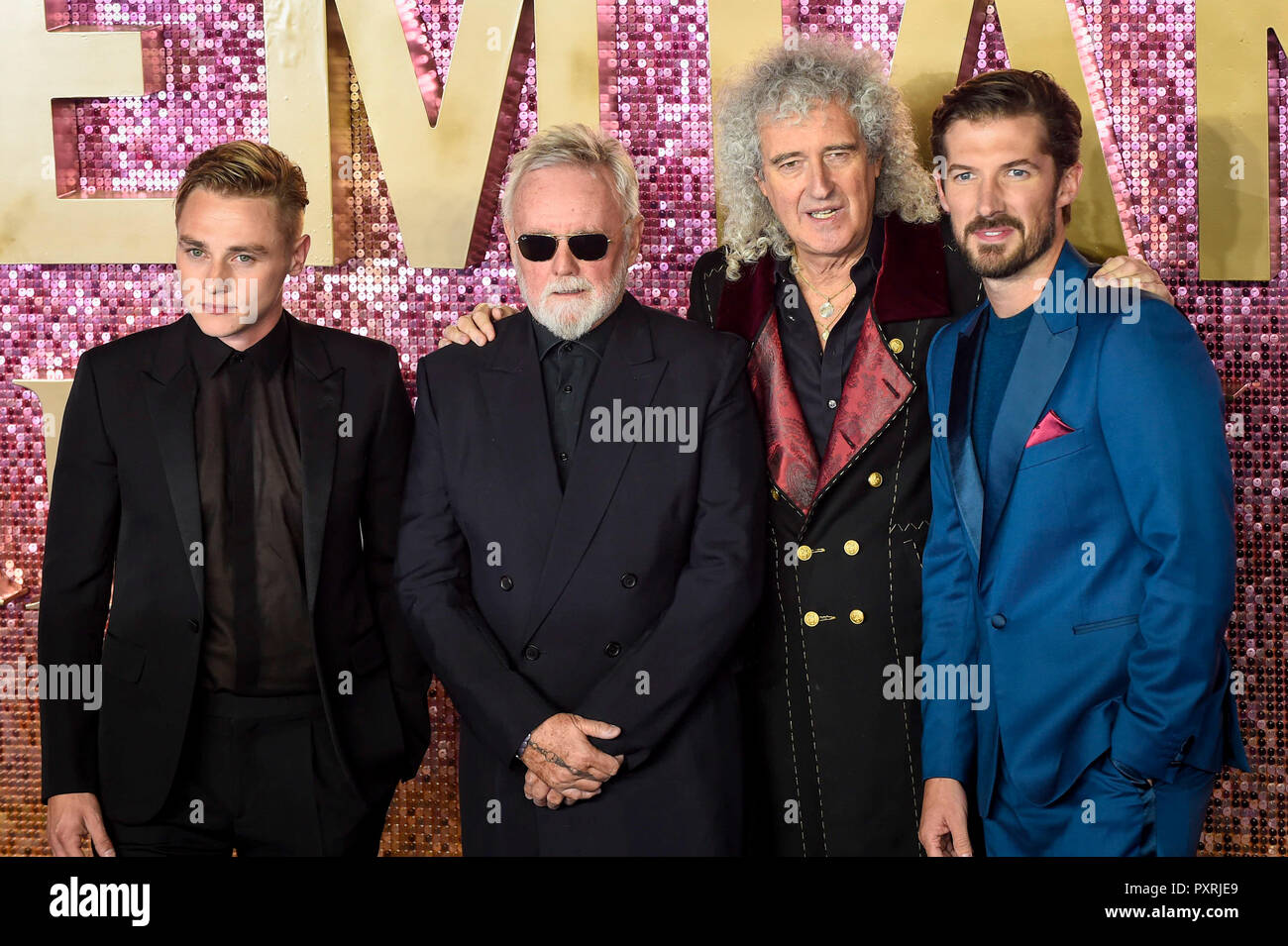 London, UK. 23 October 2018. Ben Hardy (who plays Roger Taylor), Queen's  Roger Taylor, Queen's Brian May and Gwilym Lee (who plays Brian May) arrive  for the worldwide premiere of the movie "