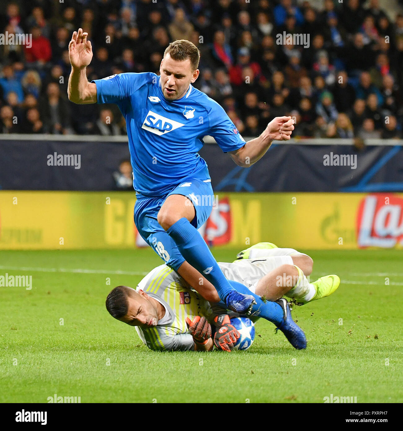 Hoffenheim, Germany. 23rd Oct, 2018. Anthony Lopes (Bottom), goalkeeper of Lyon fights for the ball during the UEFA Champions League group F match between Hoffenheim and Lyon at Rhein-Neckar-Arena in Sinsheim, Germany, on Oct. 23, 2018. The match ended 3-3. Credit: Ulrich Hufnagel/Xinhua/Alamy Live News Stock Photo