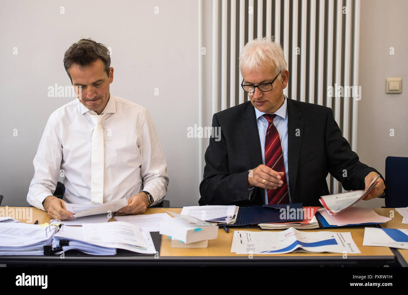 24 October 2018, Rhineland-Palatinate, Mainz: Remo Klinger (l), specialist lawyer for administrative law, sits in the courtroom on behalf of Deutsche Umwelthilfe (DUH) with Jürgen Resch, Managing Director of Deutsche Umwelthilfe, before the start of negotiations. The Administrative Court is negotiating a possible ban on diesel driving in the state capital of Rhineland-Palatinate. The case concerns a complaint by Deutsche Umwelthilfe (DUH) against the city of Mainz concerning exceeded limit values for nitrogen dioxide (NO2) in the air. Photo: Andreas Arnold/dpa Stock Photo