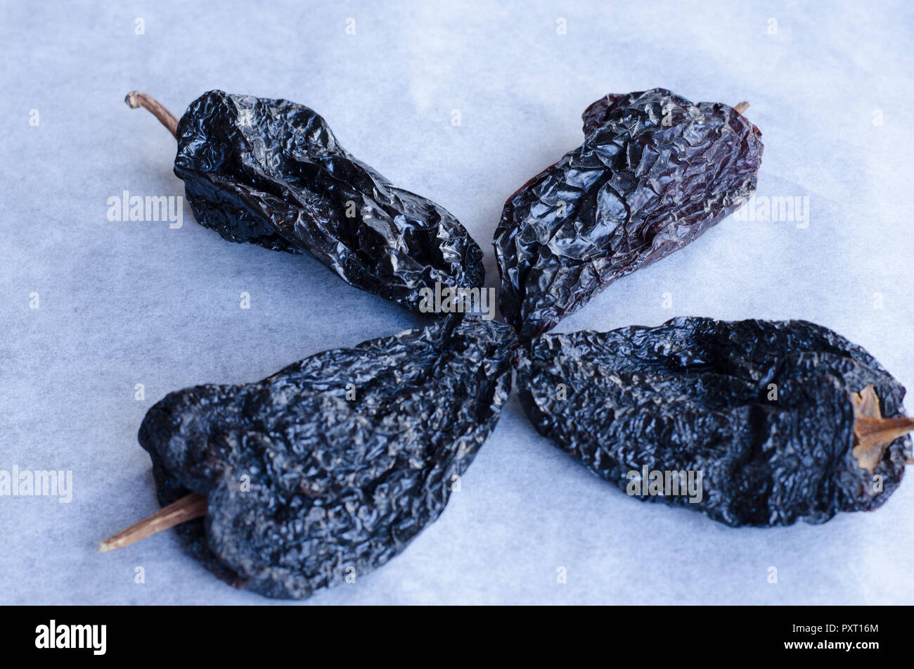A group of dried chilies, ancho and chipotle. Smokey. Stock Photo