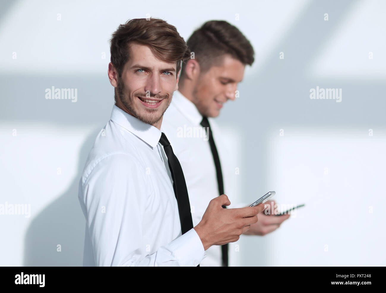 Businessmans holding mobile phone Stock Photo