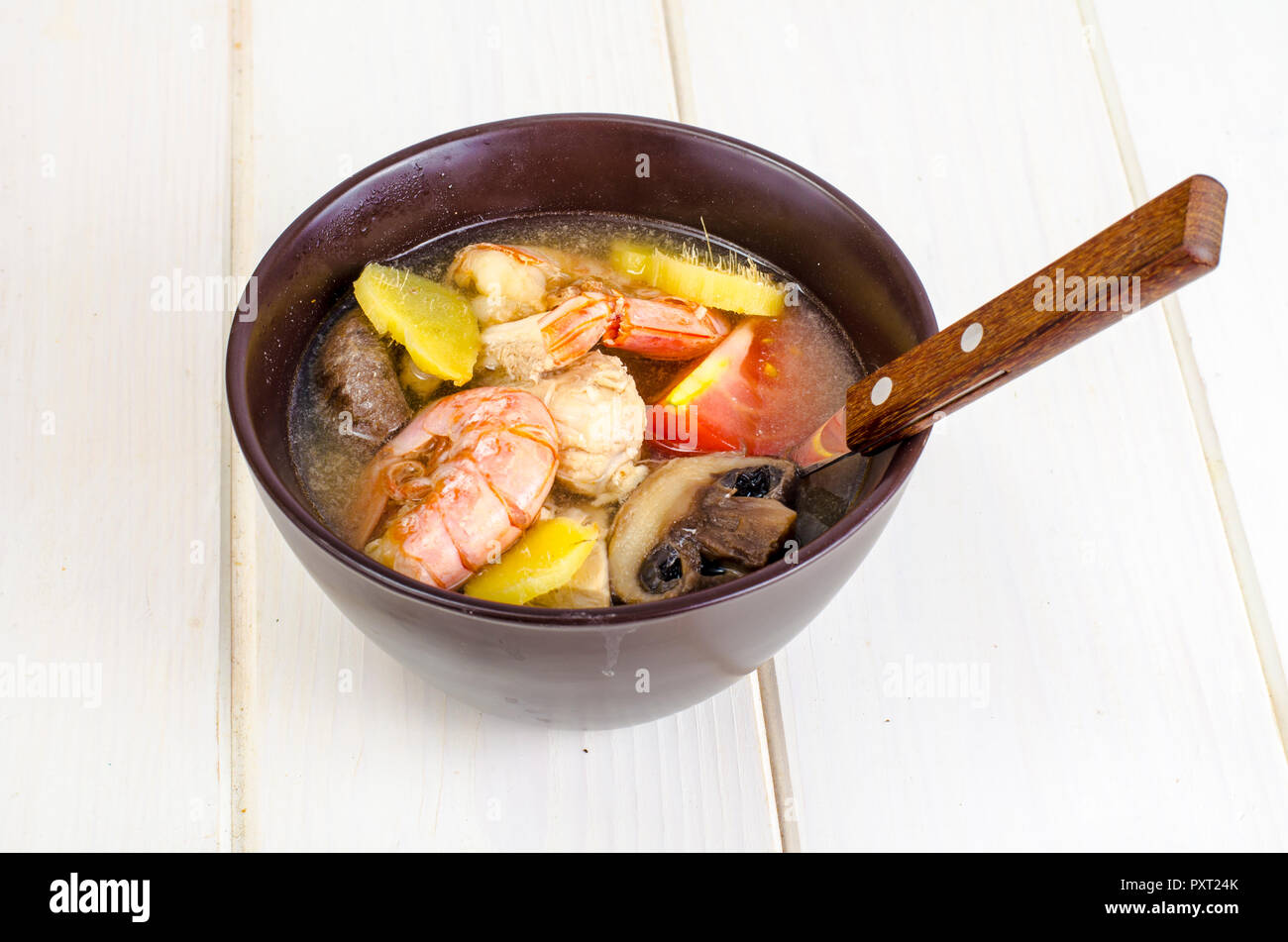 Asian cuisine. Soup with shrimps, mushrooms, chicken, ginger. Studio Photo Stock Photo