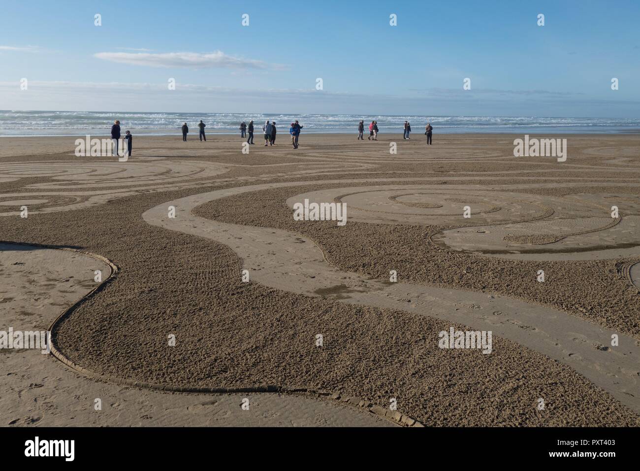 People walking a sand labyrinth, created by Denny Dyke of Circles in the Sand, in Florence, Oregon, USA. Stock Photo