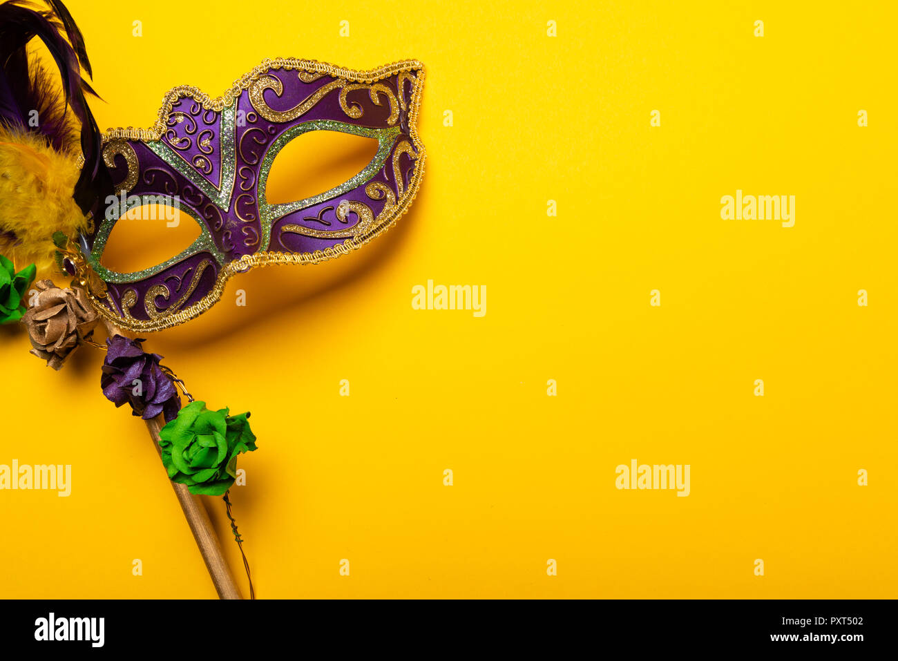 Mardi Gras mask on a yellow background Stock Photo