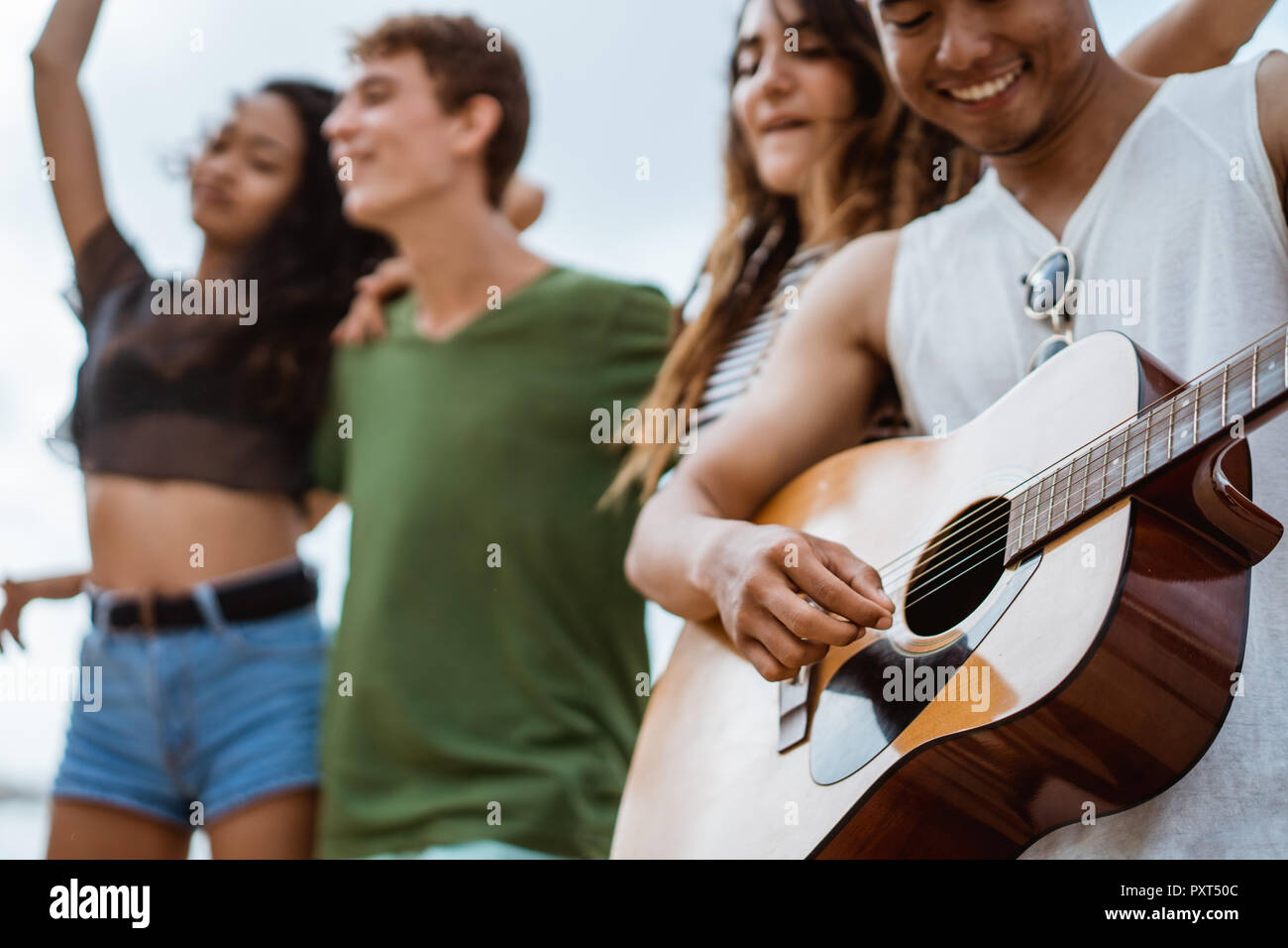 Hipster friends enjoying time at the beach Stock Photo